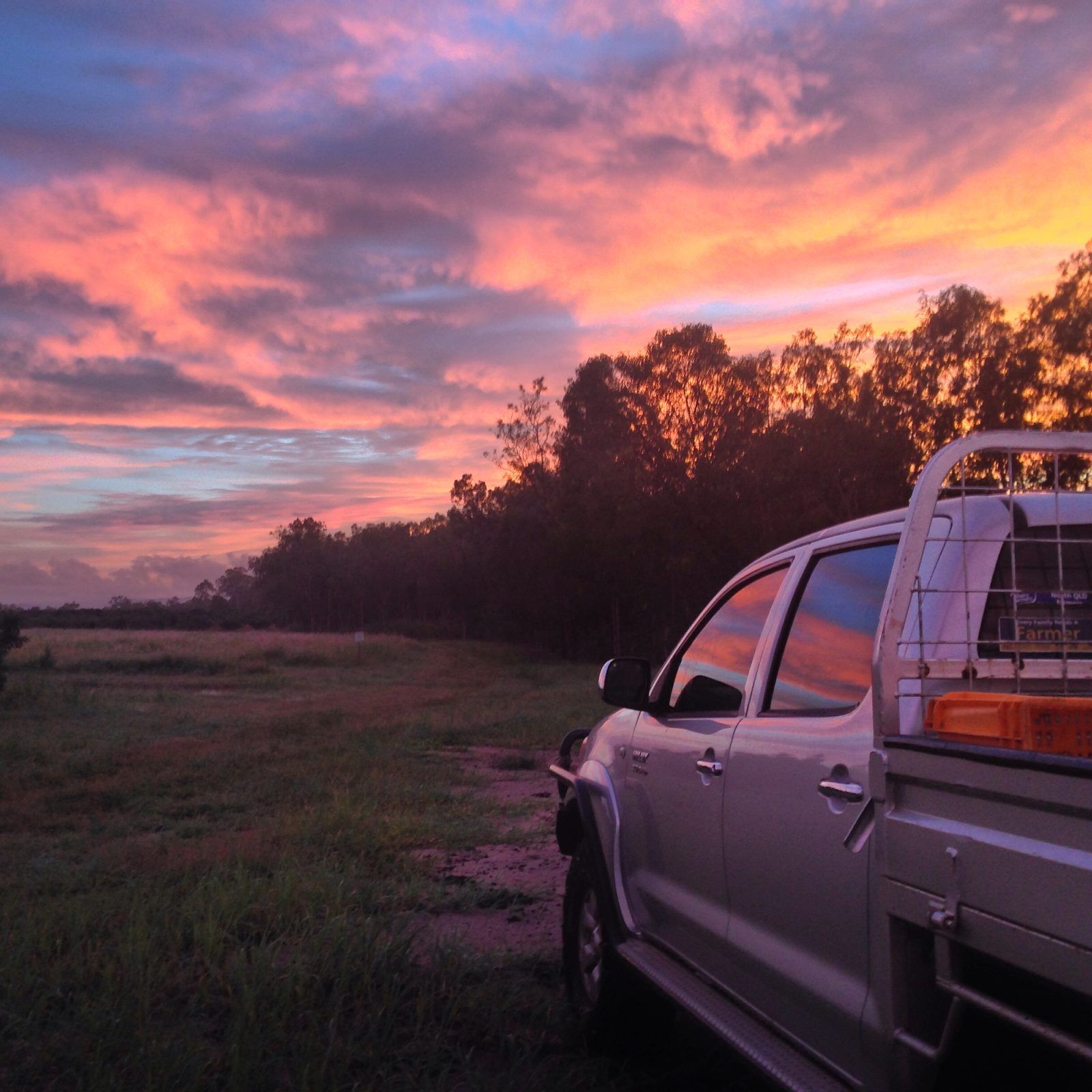 Farm ute parked on a track at Blue Sky Produce, Far North Queensland, at sunset
